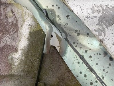 穴が開いた谷板金