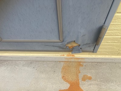 玄関ドア下部からサビ汁が発生している様子　奈良市のハイツで確認された経年劣化の症状